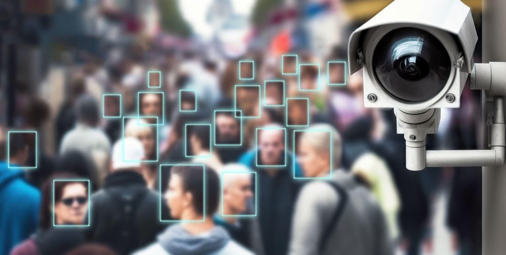Security camera using facial recognition technology to scan a crowded public space.