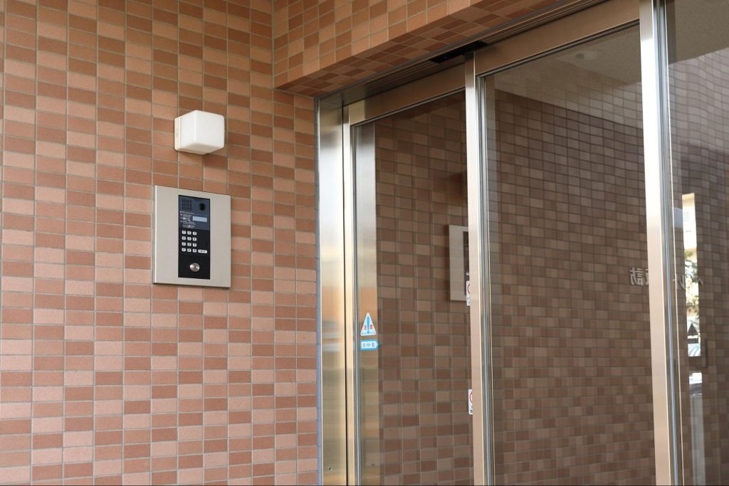 Secure access control panel next to apartment elevator doors.