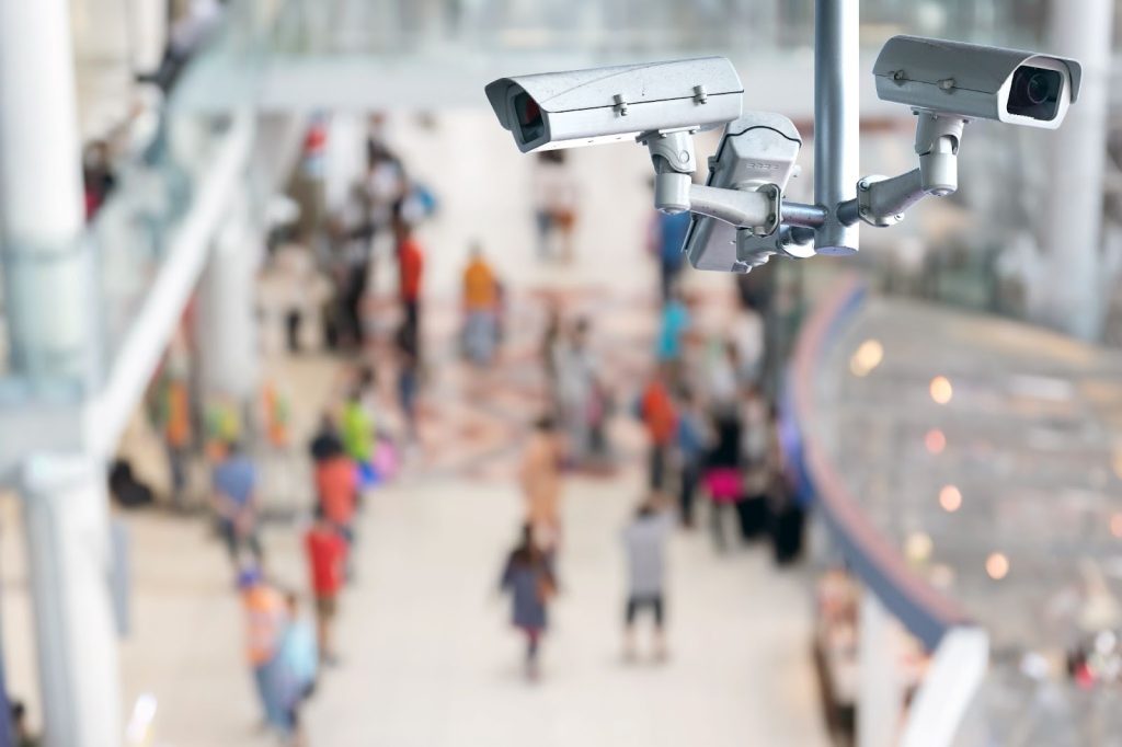 CCTV surveillance cameras monitoring a busy shopping center for operational efficiency.