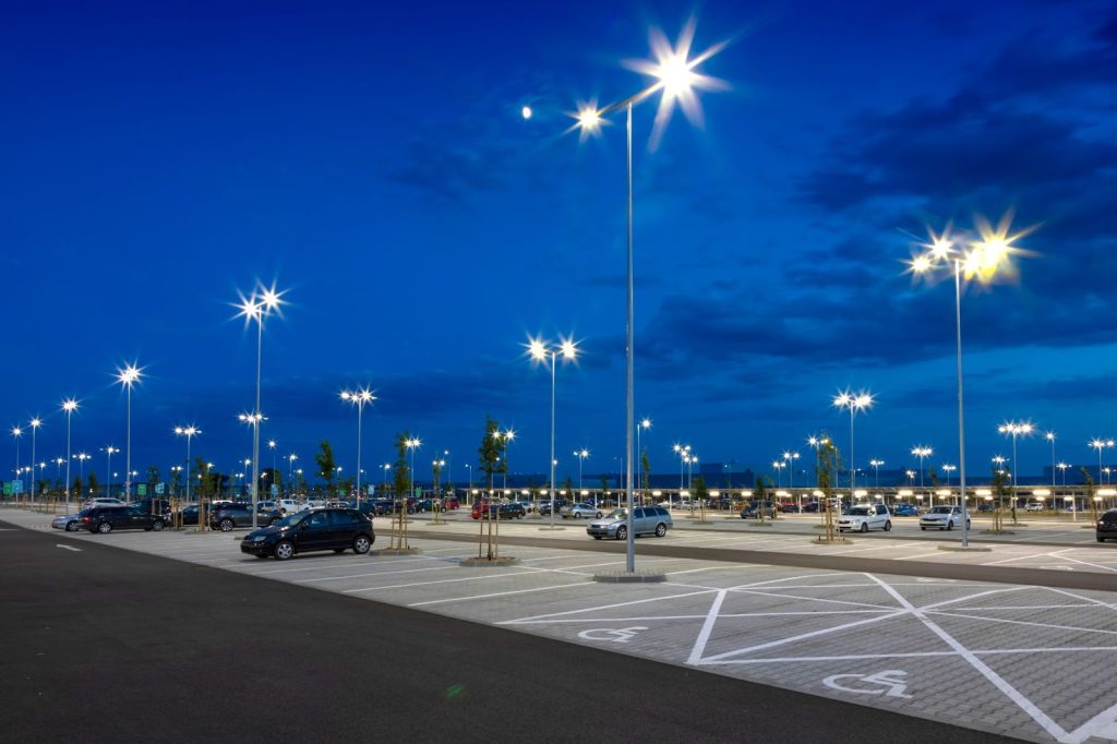 Brightly lit parking lot enhancing visibility and safety, demonstrating effective ways to secure parking spaces.