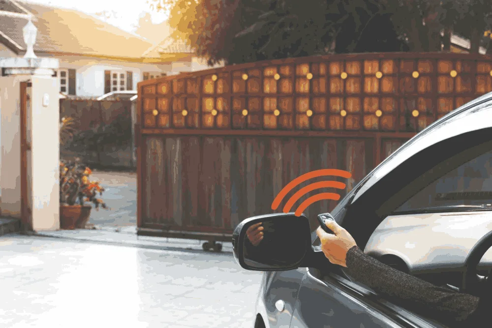 Automatic gate being opened remotely with a car remote control.
