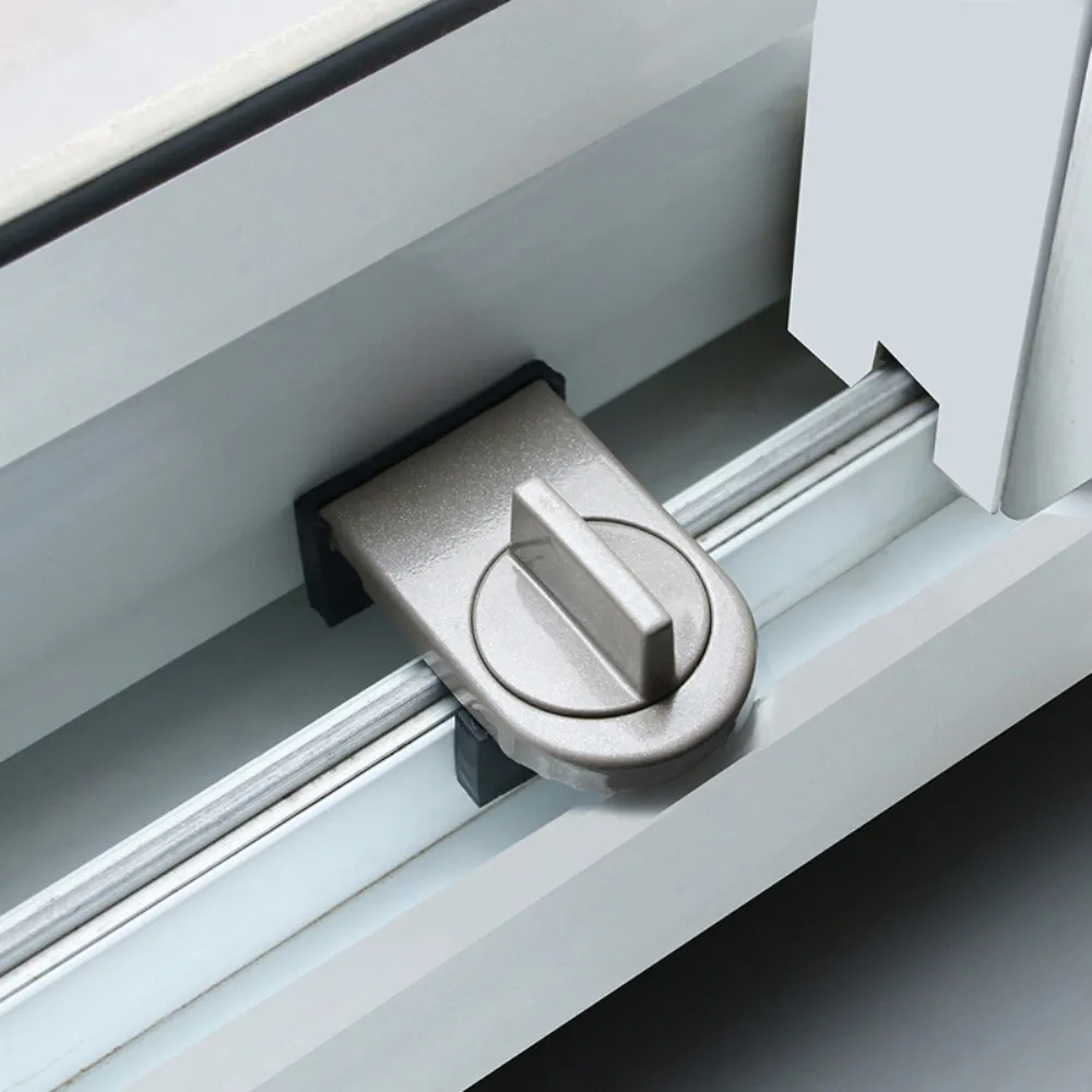 Close-up of a secure window lock on a sliding window.
