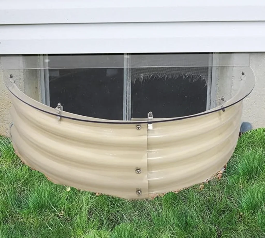 Transparent window well cover installed to protect basement windows.