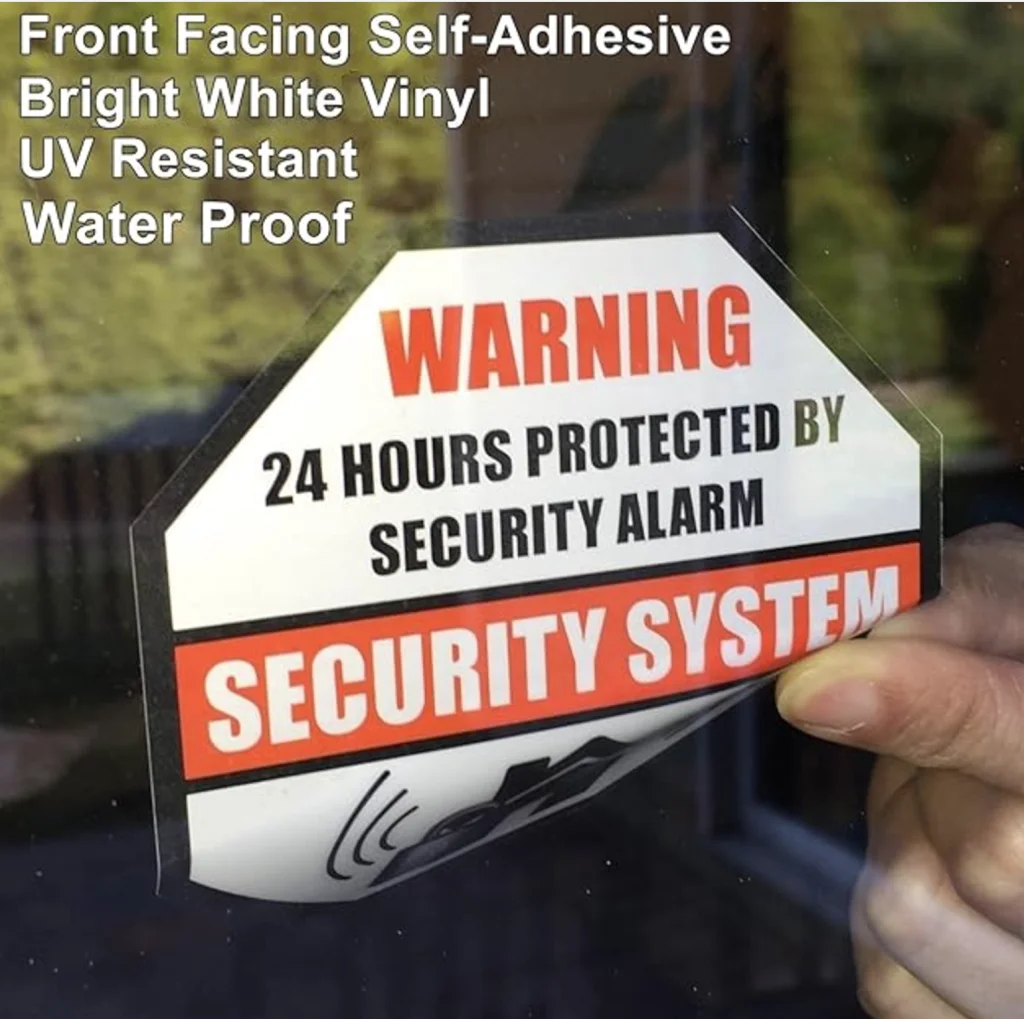 Warning sticker stating 24-hour protection by a security alarm system.