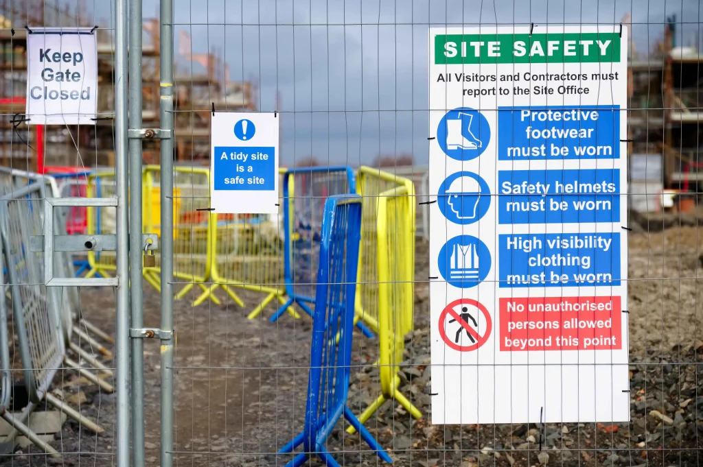 Construction site security signs for safety protocols and restricted access points.