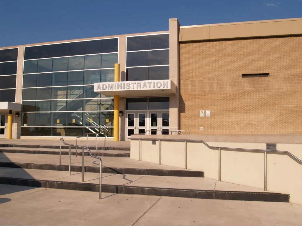School administration building entrance monitored as part of campus security infrastructure.