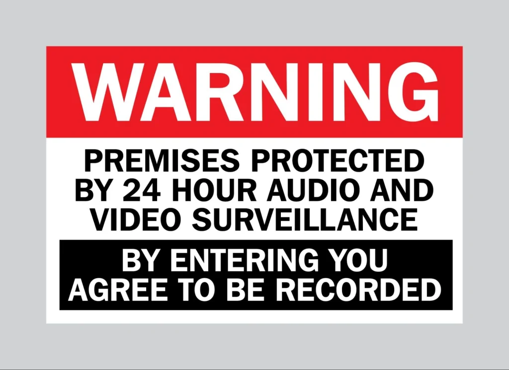 Warning sign indicating video and audio surveillance on premises.